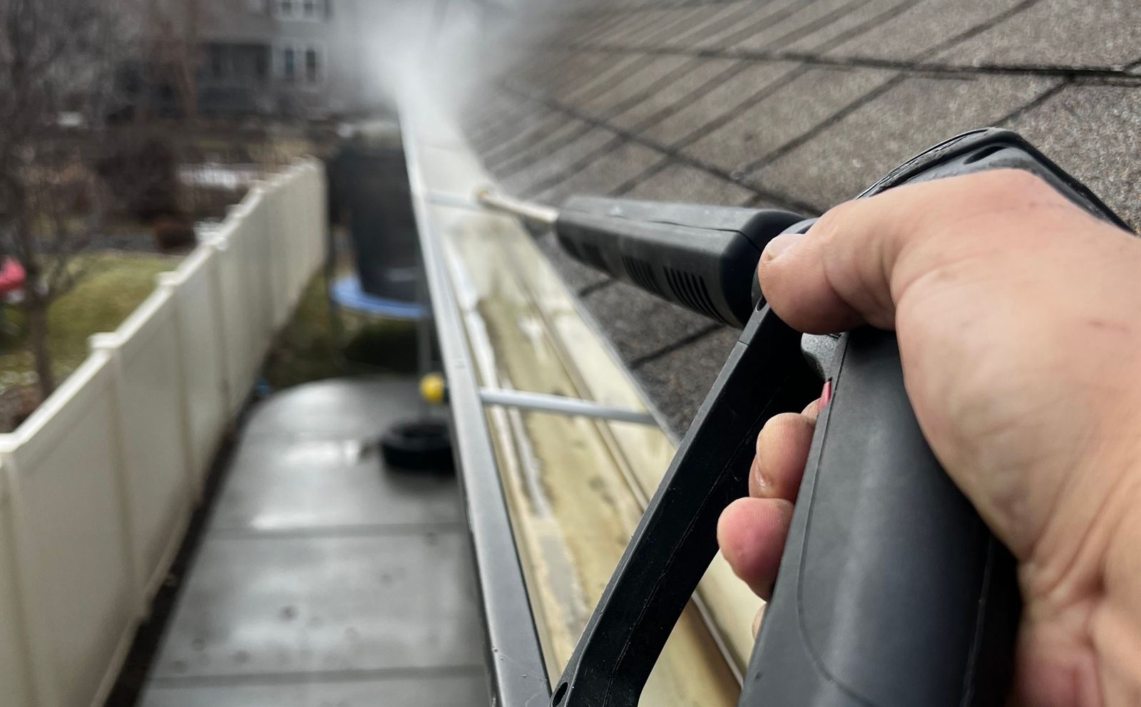 Debris being cleared from a roof gutter — gutter cleaning in Charlottesville, VA