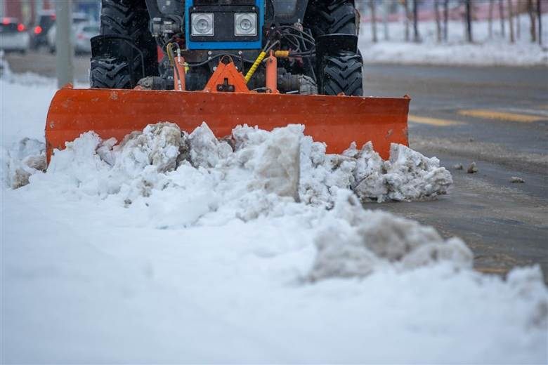 Snow plow clearing a driveway after snowfall — snow removal service, Charlottesville, VA